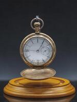 old pocket watch a family heirloom from several generations ago hanging in its display case face open with out the dome photo