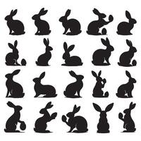 Set of black silhouettes of rabbits in various poses vector