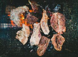 Grilled Meat on Barbecue, Closeup of Juicy Steaks and Pork Cooking Over Open Fire, High-Quality BBQ Stock Image for Food Photography and Culinary Concepts. photo