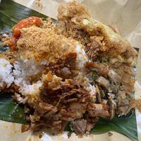 Embracing the vibrant flavors of Indonesia with a plate of nasi rames. A delicious mix of rice and savory dishes that is truly comforting photo
