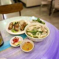 Slurping up the best of Vietnam with a steaming bowl of pho and fresh spring rolls. A perfect combo of comfort and crunch photo