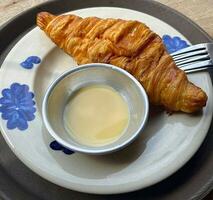 Indulging in a buttery bliss, croissant meets milk photo