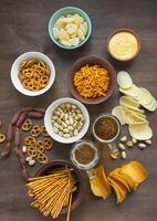 Beer snacks on a wooden table. View from above. Close-up. Copy space. photo