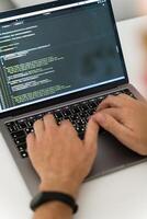 A cropped image of a young man working on a computer. photo