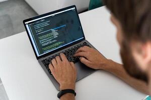 Programmer typing new lines of HTML photo