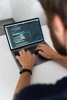 A cropped image of a young man working on a computer. photo