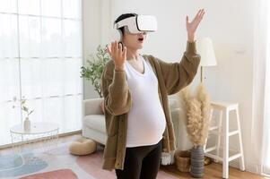 Pregnant woman wearing vr box using future technology for entertainment in living room photo