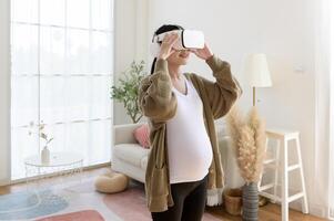 Pregnant woman wearing vr box using future technology for entertainment in living room photo
