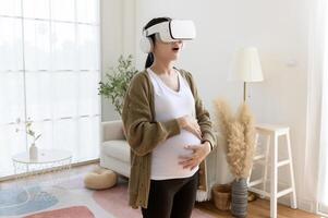 Pregnant woman wearing vr box using future technology for entertainment in living room photo