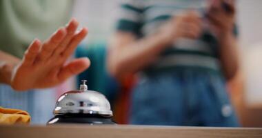 Selective focus, Young asian woman live-streamed selling clothes and pressed a bell to attract customers' attention in home studio. Remote buying, Online shopping. photo
