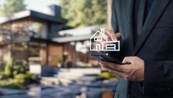 A man in a suit holding a smartphone with a house icon on it photo