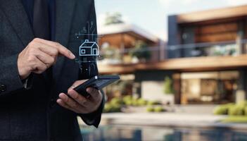 A man in a suit holding a smartphone with a house icon on it photo