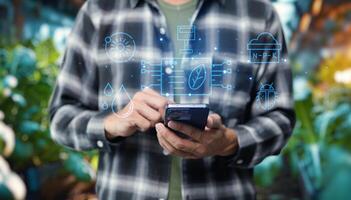 Man using smartphone with digital icons on background photo