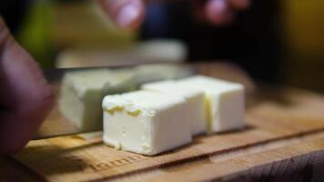 Cut butter into cubes for baking cake, Whole Pieces of Fresh Butter on The Wooden, Close-up, Macro, and Rotate. Isolated Background of Natural Butter Bars. video