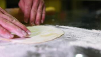 roll out dough, thin layer process of croissant preparation.starting with adding flour, in dough mixer,is rolled out thinly.after laminating,dough is chilling.many croissant on tray.4k video