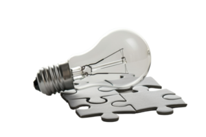 Concept image of a light bulb resting on a jigsaw puzzle, symbolizing ideas, innovation, and problem-solving. png