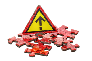 Warning sign atop scattered puzzle pieces, highlighting caution in problem-solving and risk management. Conceptual stock photo. png