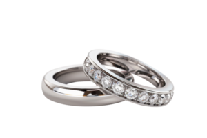 Close-up of two elegant silver wedding rings, one adorned with sparkling diamonds, isolated on a transparent background. png