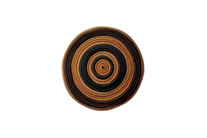 Handwoven circular basket with intricate black and brown patterns, isolated on a transparent background. png