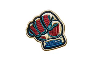 Colorful embroidered fist symbol patch on transparent background, representing strength, power, and unity in a vivid design. png
