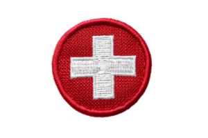 Swiss flag patch isolated on transparent background. Red circle badge with white cross symbol for national identity and travel. Embroidered design. png