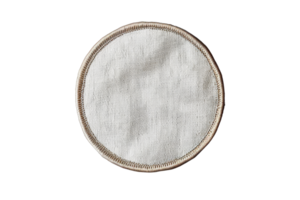 Close-up of a round white fabric coaster with a beige border, isolated on a transparent background. ideal for home decor and table settings. png