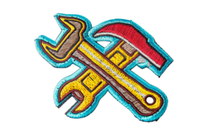Colorful embroidered patch featuring a hammer and wrench crossed, symbolizing tools and repair work, perfect for DIY enthusiasts. png
