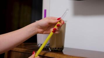 Buble Tea Boba or tapioca pearls is taiwan bubble milk tea in plastic cup with brown sugar flavor on texture background, summers refreshment. video