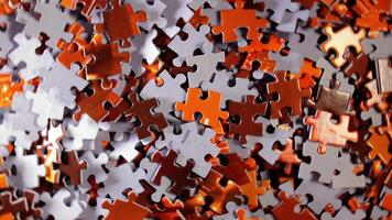 Background of Colored Puzzle Pieces that Rotating Counterclockwise - Top View. Texture of Incomplete Red and Grey Jigsaw Puzzle - Left Rotation video