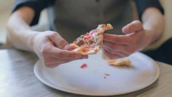 Handsome Young Man Eating Pizza in Pizzeria Cafe. Youthfull Customer or Office Worker Has a Break. Close-Up View, Dynamic Shot video