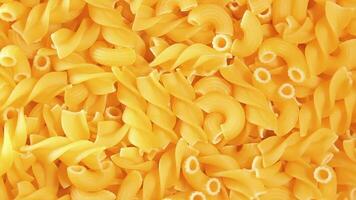 Uncooked Fusilli and Chifferi Rigati Pasta - Top View. Fat and Unhealthy Food. Classic Dry Macaroni, Slowly Rotating Background. Raw Different Macaroni Pasta Texture - Rotate Left video