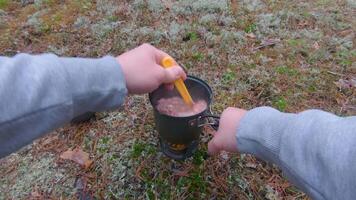 Camp Food. Cooking in a Forest Using a Small Cook Set - First Person View, Wide Angle. Food on the Trip. Traveler in a Forest. Tourist in a Travel is Heating Food - POV Shot video