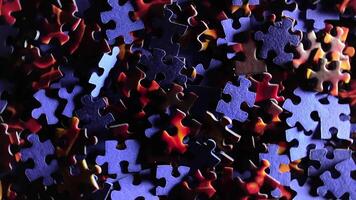 Background of Colored Puzzle Pieces that Rotating Clockwise - Top View. Texture of Incomplete Red and Blue Jigsaw Puzzle with Low Key Light - Right Rotation video