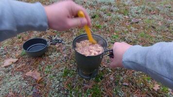 Camp Food. Cooking in a Forest Using a Small Cook Set - First Person View, Wide Angle. Food on the Trip. Traveler in a Forest. Tourist in a Travel is Heating Food - POV Shot video