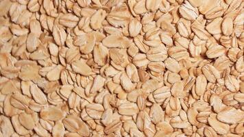 Oat Flakes Background Slowly Rotating Clockwise - Top View. Scattered Dry Oat Flakes. Healthy Breakfast and Diet Eating Ingredients - Angular Rotation Right video
