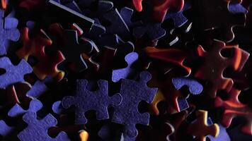 Background of Colored Puzzle Pieces that Rotating Counterclockwise - Top View, Close-Up. Texture of Incomplete Red and Blue Jigsaw Puzzle with Low Key Light - Left Rotation video