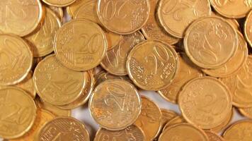 Scattered 20 Euro Cent Coins, Rotating Money Background - Top View. Euro Money Currency. A Lot of Twenty Cent Cash. Golden Eurocents. Business, Finances and Money Saving Concept - Slow Rotation Left video