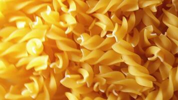 Uncooked Fusilli Pasta with Spiral Form - Rotating Background, Top View. Golden Raw and Dry Fusilli Macaroni Texture Rotate. Italian Culture and Cuisine video
