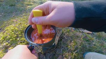 Camp Food. Cooking in a Hike Using a Small Cook Set - First Person View, Wide Angle. Food on the Trip. Traveler in a Spring Forest. Tourist in a Travel is Heating Food - POV Shot. video