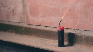 Firecracker Was Lighted Up With a Gas Lighter then Explode Against a Brick Wall. Many Small Particles Flew in a Different Directions - Static Shot video