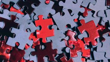 Background of Colored Puzzle Pieces that Slowly Rotating Clockwise - Top View, Close-Up. Texture of Incomplete Red and Grey Jigsaw Puzzle - Right Rotation video