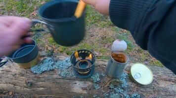 Camp Food. Cooking in a Hike Using a Small Cook Set - First Person View, Wide Angle. Food on the Trip. Traveler in a Spring Forest. Tourist in a Travel is Heating Food - POV Shot. video