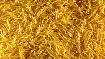 Background of Uncooked Noodles that Slowly Rotating Clockwise - Top View, Close-Up. Texture of Dry Vermicelli Turning Around. Raw Pasta with Low Key Light - Right Rotation video