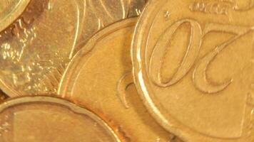 Scattered 20 Euro Cent Coins, Rotating Money Background - Top View, Macro. Euro Money Currency. A Lot of Twenty Cent Cash. Golden Eurocents. Business, Finances and Money Saving Concept - Rotation Left video