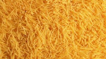 Background of Uncooked Noodles that Rotating Counterclockwise - Top View, Close-Up. Texture of Dry Vermicelli Turning Around. Raw Pasta - Left Rotation video