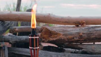 Tropical Bamboo Torch Burning in the Beach at Summer Evening. Decorative Candle Has a Massive Orange Flame Using Oil Fuel or Kerosene - Slow Motion. Static Shot video