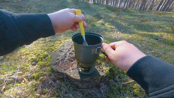 Camp Food. Cooking in a Hike Using a Small Cook Set - First Person View, Wide Angle. Food on the Trip. Traveler in a Spring Forest. Tourist in a Travel is Heating Food - POV Shot. video