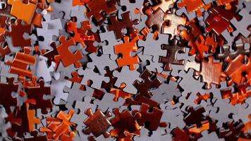 Background of Colored Puzzle Pieces that Rotating Counterclockwise - Top View. Texture of Incomplete Red and Grey Jigsaw Puzzle - Left Rotation video