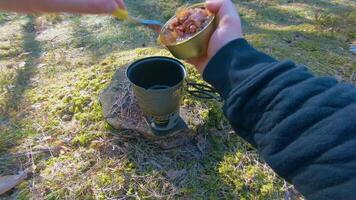 Camp Food. Cooking in a Hike Using a Small Cook Set - First Person View, Wide Angle. Food on the Trip. Traveler in a Spring Forest. Tourist in a Travel is Heating Food - POV Shot. video
