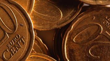 Scattered 20 Euro Cent Coins, Rotating Money Background - Top View, Macro. Euro Money Currency. A Lot of Twenty Cent Cash. Business, Finances and Money Saving Concept - Slow Rotation Left video